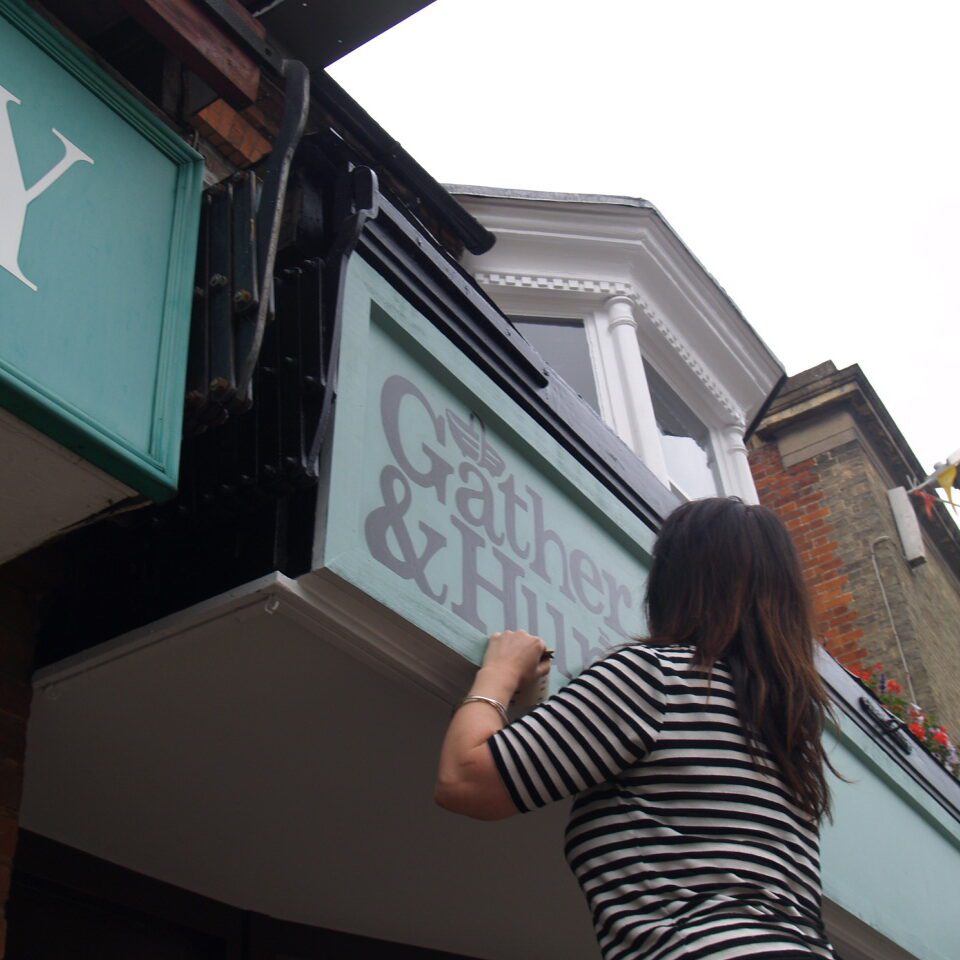 Sign painting a shop fascia sign for Gather & Hunt