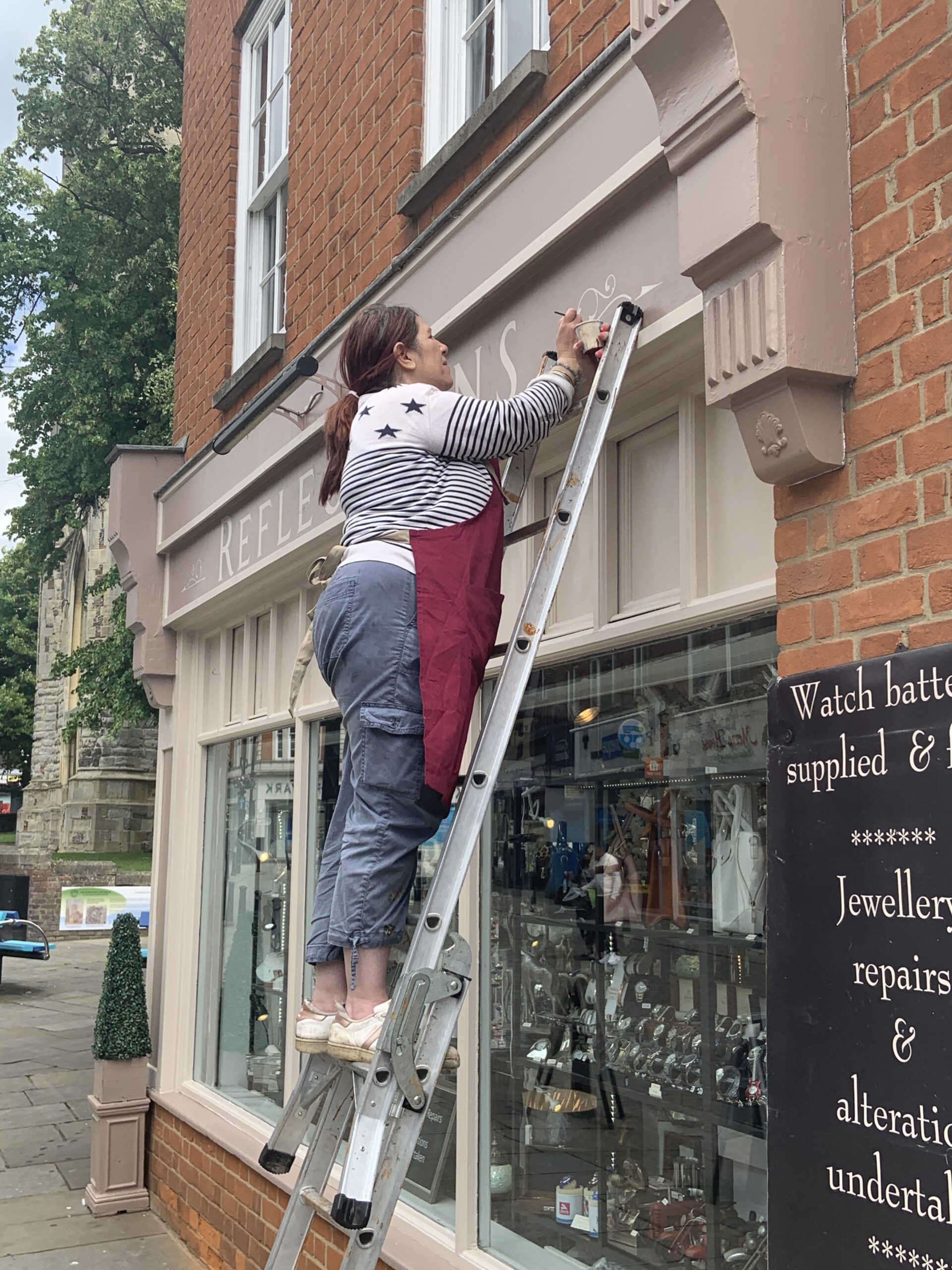 Commission bespoke signs and gold-Painting a shop sign traditionally hand-lettered & hand-painted in Roman style letttering