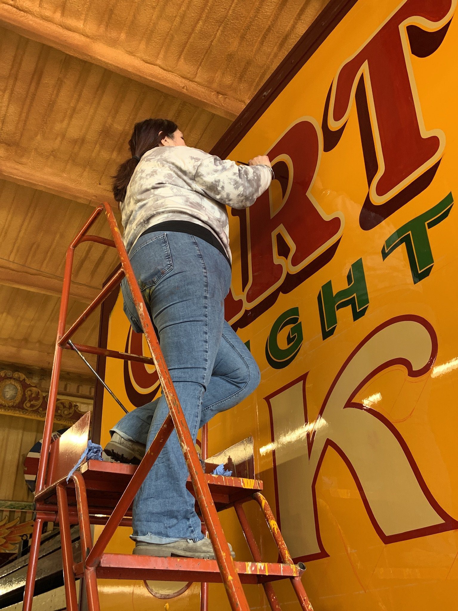 Me up a tall ladder stair, signpainting huge lettering on the side of Carters Steam Fair truck