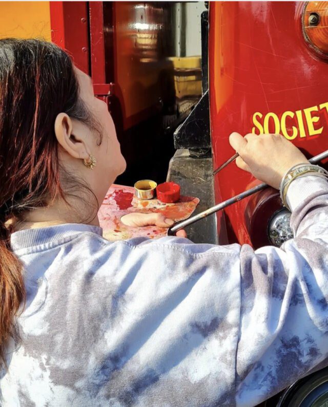 Me painting letters onto one of the Carters Steam Fair trucks