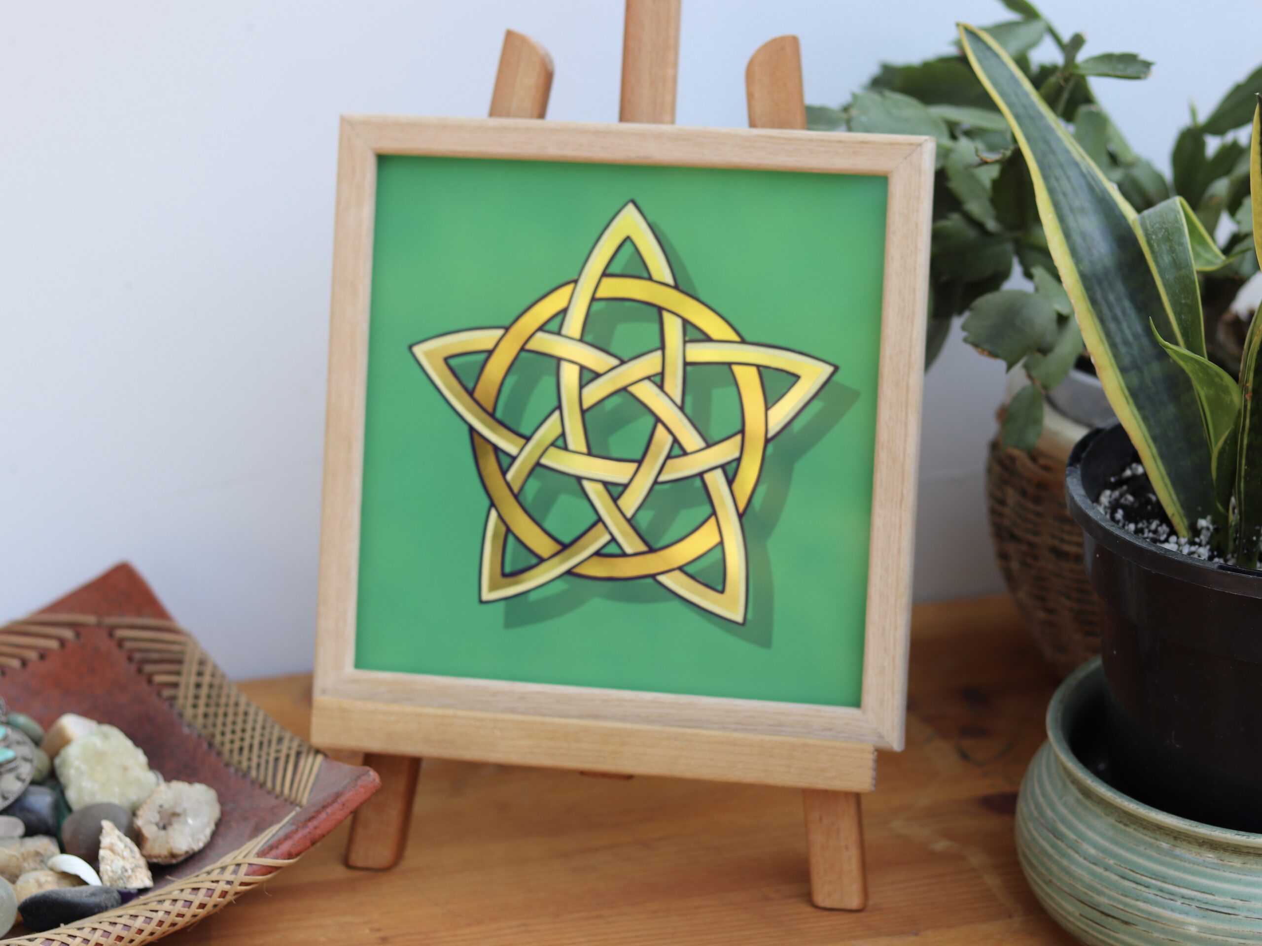 Stunning gold leaf mirror effect 5 pointed celtic knot star in 2 colours of genuine gold leaf on a green background and framed in oak wood