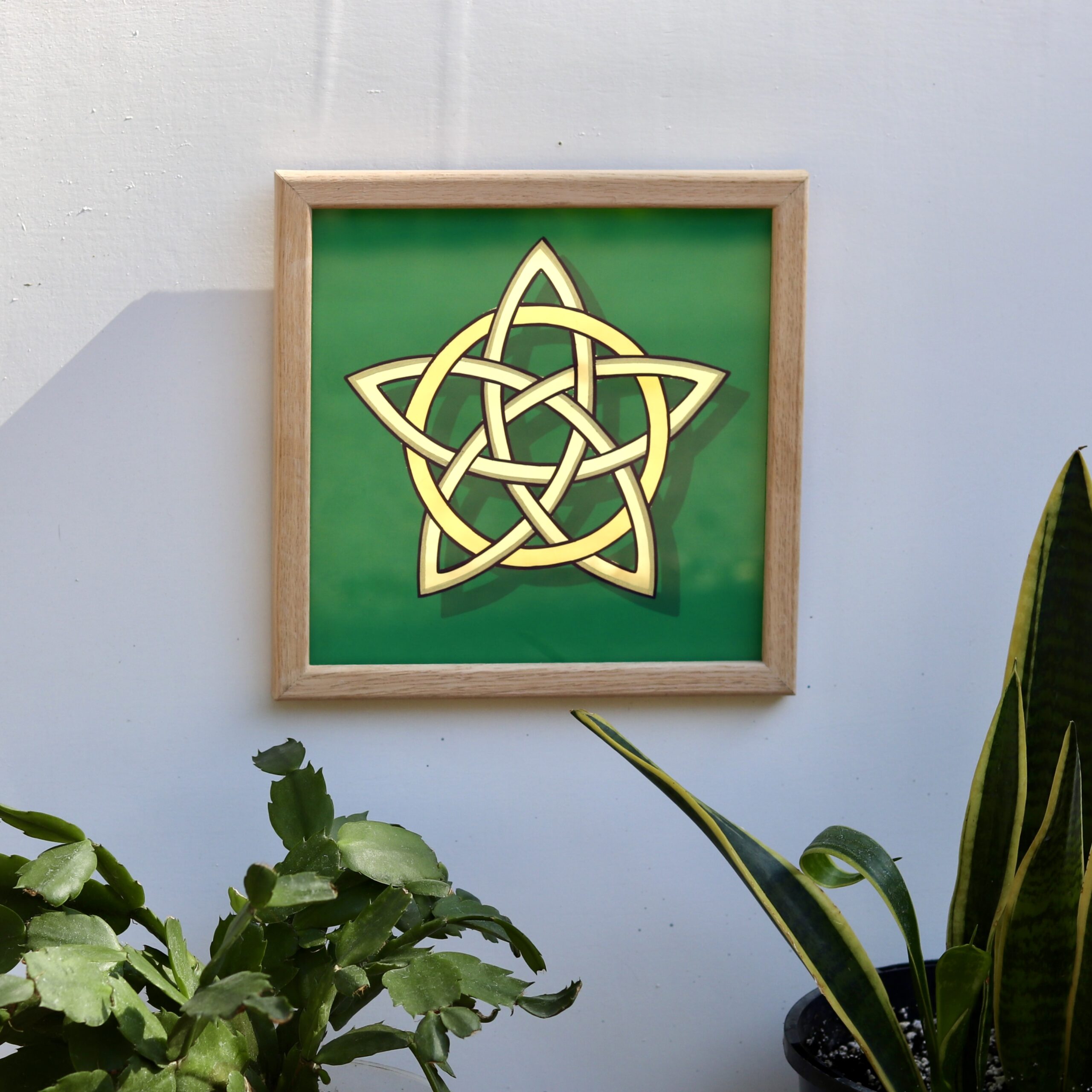 Stunning gold leaf mirror effect 5 pointed celtic knot star in 2 colours of genuine gold leaf on a green background and framed in oak wood