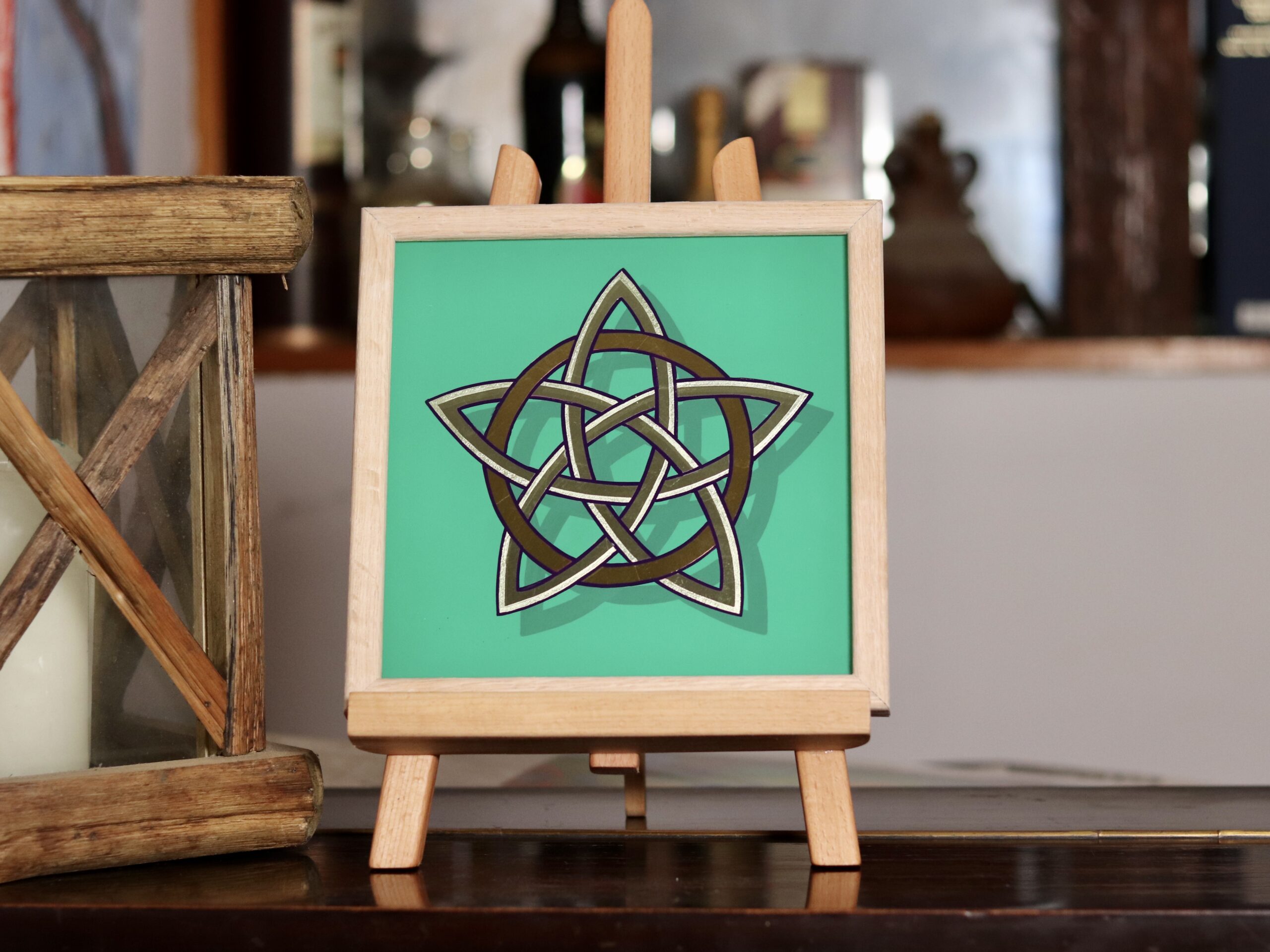 Stunning gold leaf mirror effect 5 pointed celtic knot star in 2 colours of genuine gold leaf on a green background and framed in oak wood