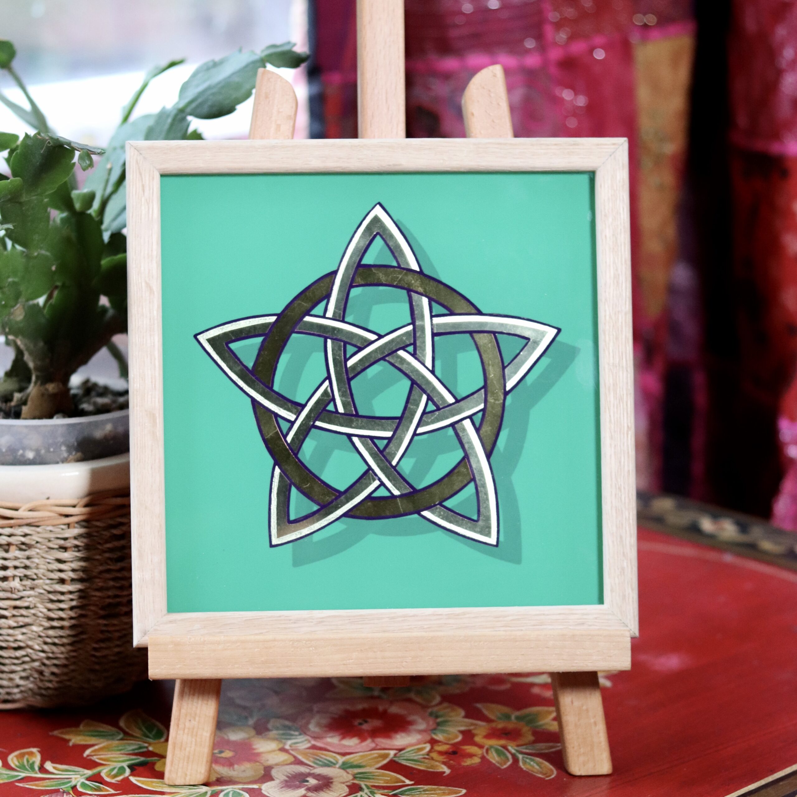 Stunning gold leaf mirror effect 5 pointed celtic knot star in 2 colours of genuine gold leaf on a green background and framed in oak wood