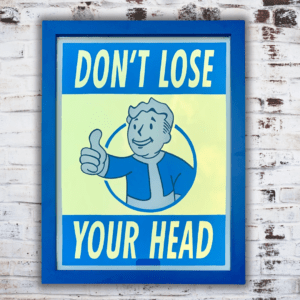 Reverse Glass Gilded wall art of featuring Pip- Vault Boy from FALLOUT and lettering 'Dont Lose Your Head' in 23ct gold leaf, cream & blue paint and finished in a blue wood frame