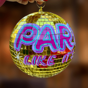 'Party like it's 1999' DISCO mirror ball. Casual style handpainted lettering in magenta and teal enamel paints onto gold mirror ball measuring approx 30cm diameter