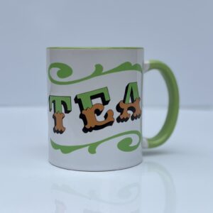 White & green ceramic mug with Circus Style hand-lettered ‘TEA’ design