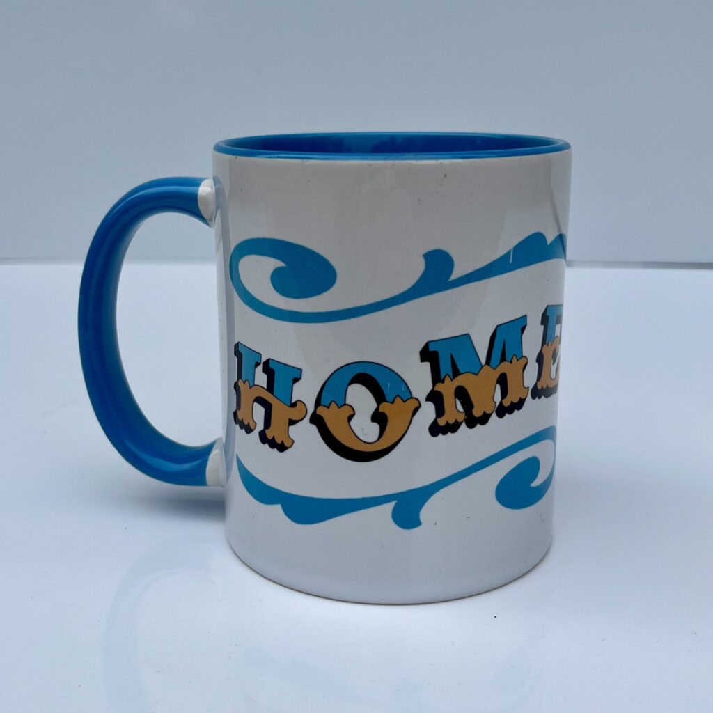 White & blue ceramic mug with Circus Style hand-lettered ‘HOME’ design