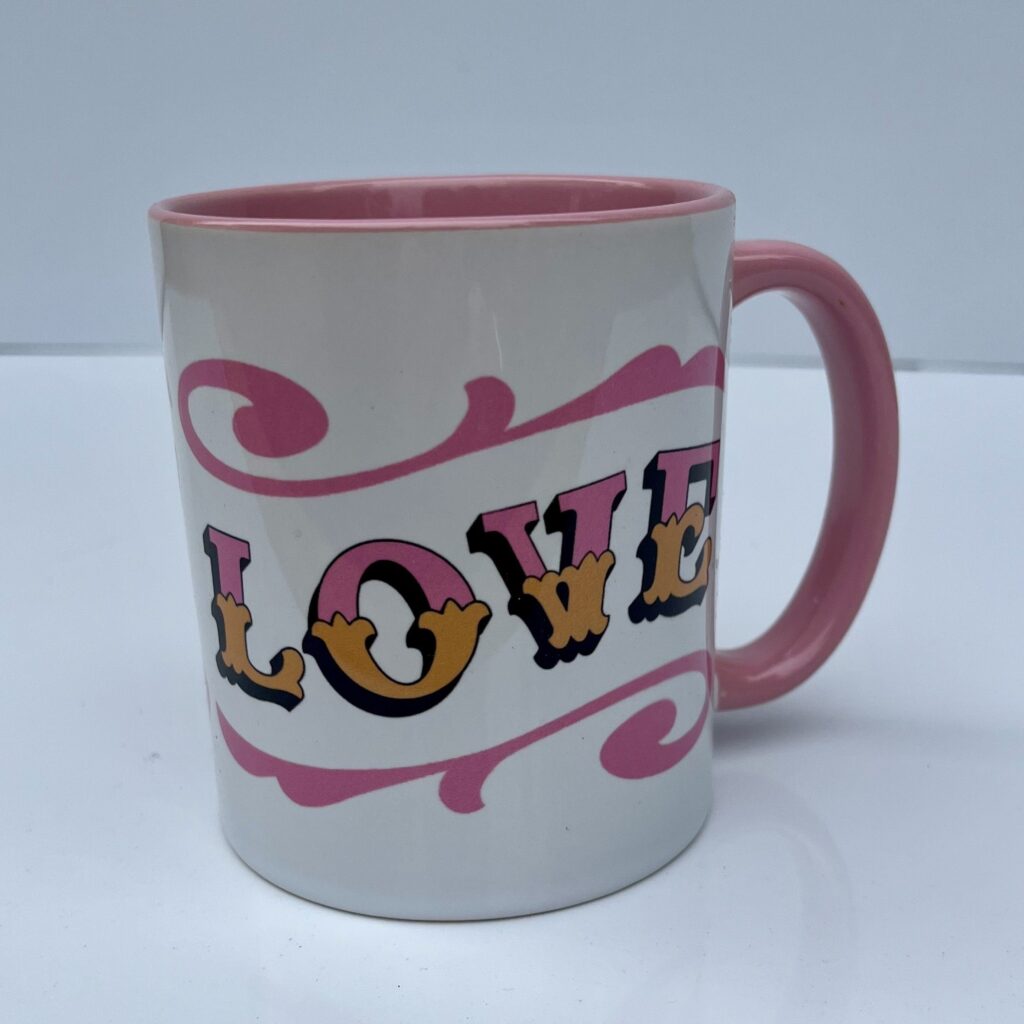 White & pink ceramic mug with Circus Style hand-lettered ‘LOVE’ design