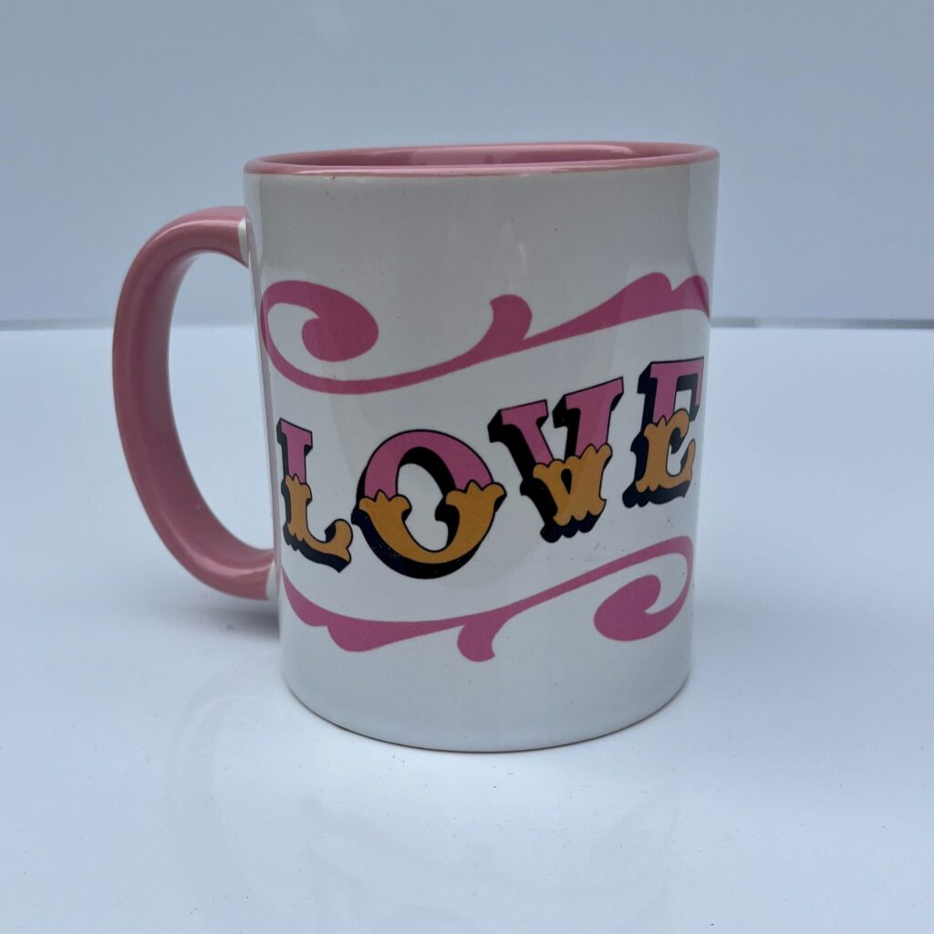 White & pink ceramic mug with Circus Style hand-lettered ‘LOVE’ design