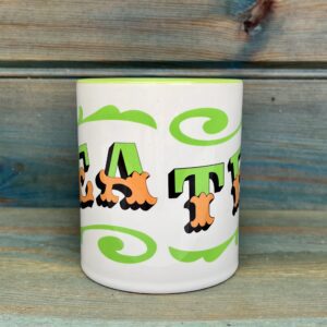 White & green ceramic mug with Circus Style hand-lettered ‘TEA’ design