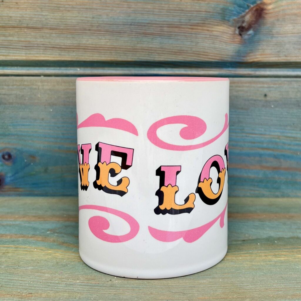 White & pink ceramic mug with Circus Style hand-lettered ‘LOVE’ design