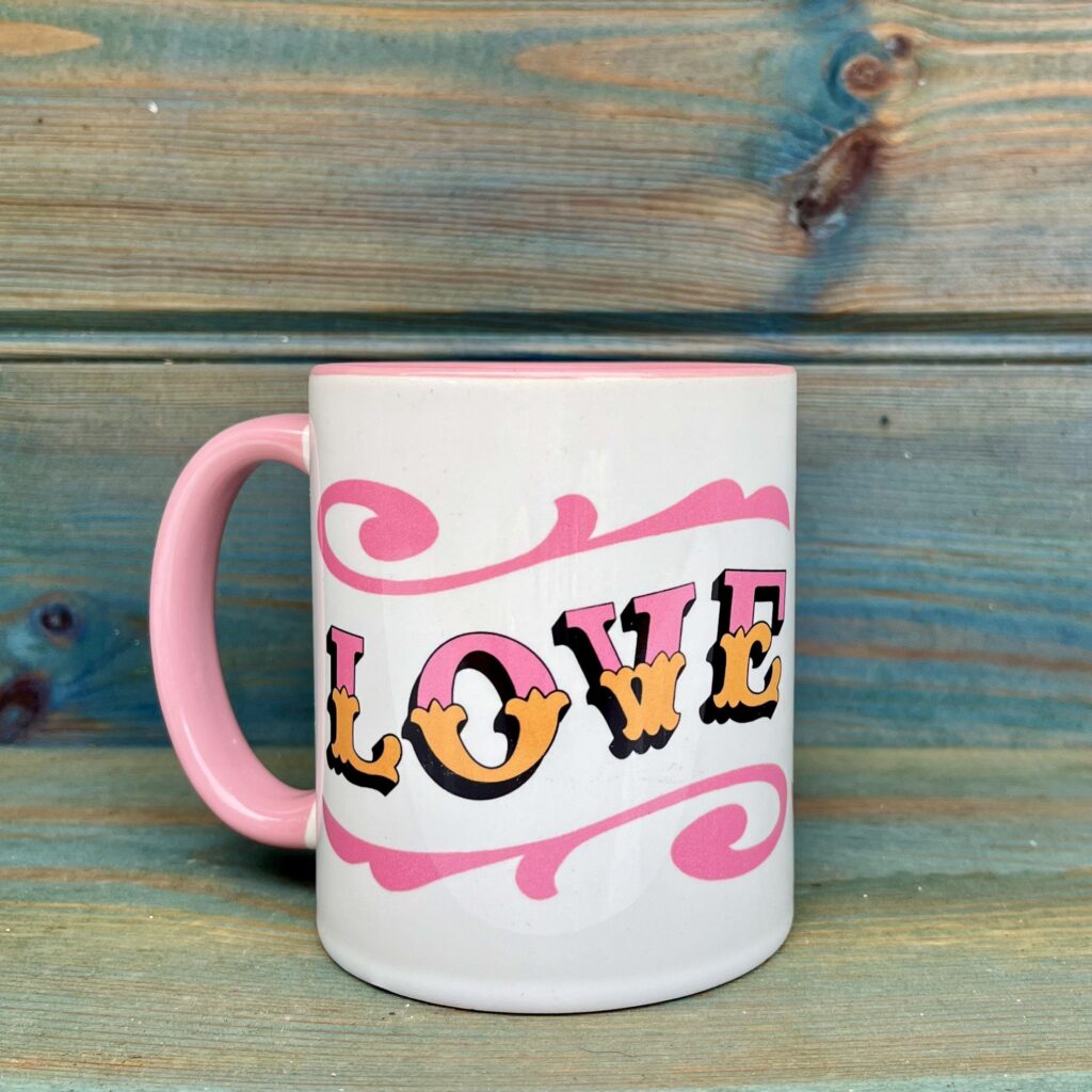 White & pink ceramic mug with Circus Style hand-lettered ‘LOVE’ design