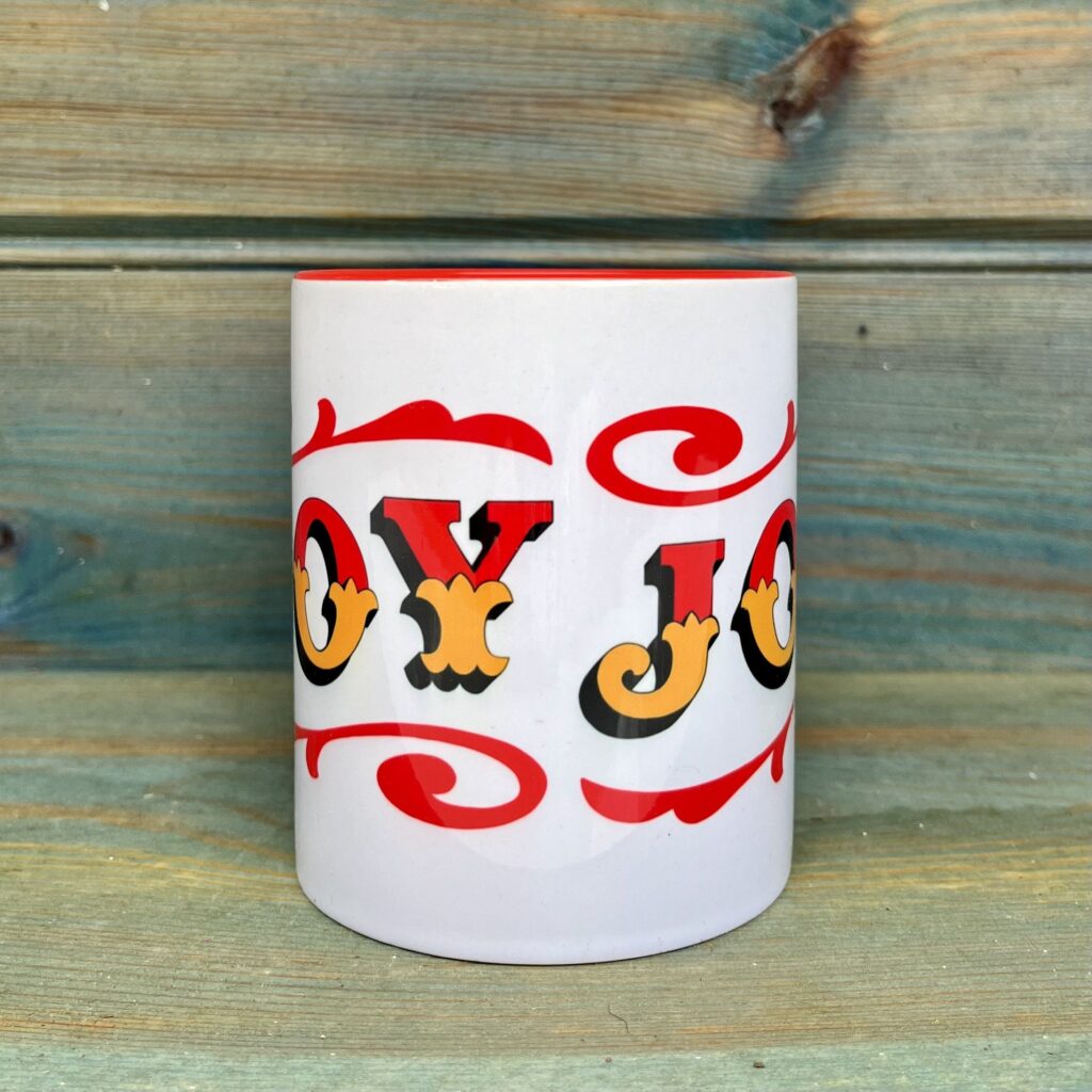 White & red ceramic mug with Circus Style hand-lettered ‘JOY’ design