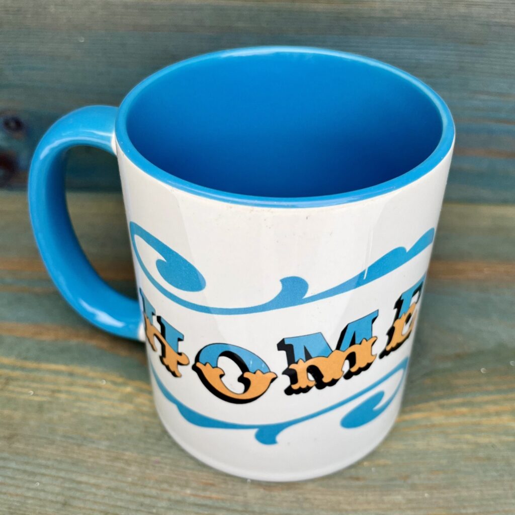 White & blue ceramic mug with Circus Style hand-lettered ‘HOME’ design