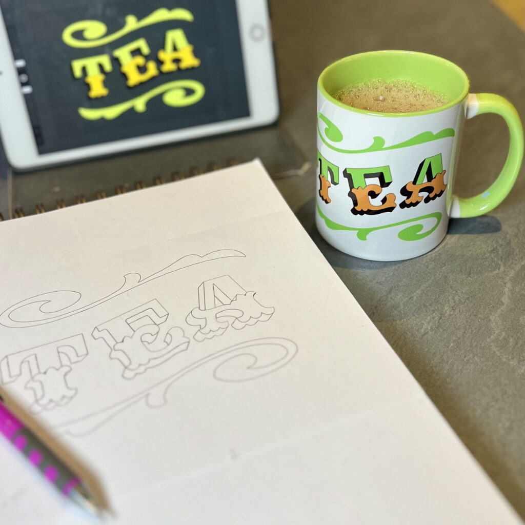 White & green ceramic mug with Circus Style hand-lettered ‘TEA’ design with the original drawings of the design