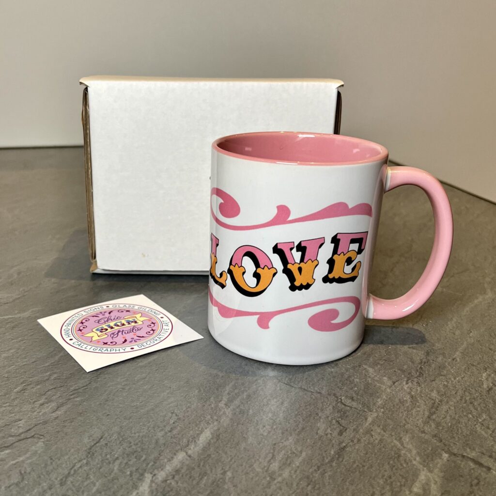 Circus Style hand-lettered ‘LOVE’ pink and white ceramic mug with colour inside with postage box