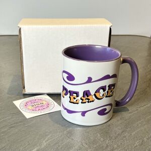 White & purple ceramic mug with Circus Style hand-lettered ‘PEACE’ design