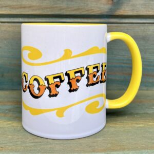 White ceramic 11oz mug with circus style COFFEE lettering design wrap around and colourful yellow rim, handle and inside, side view