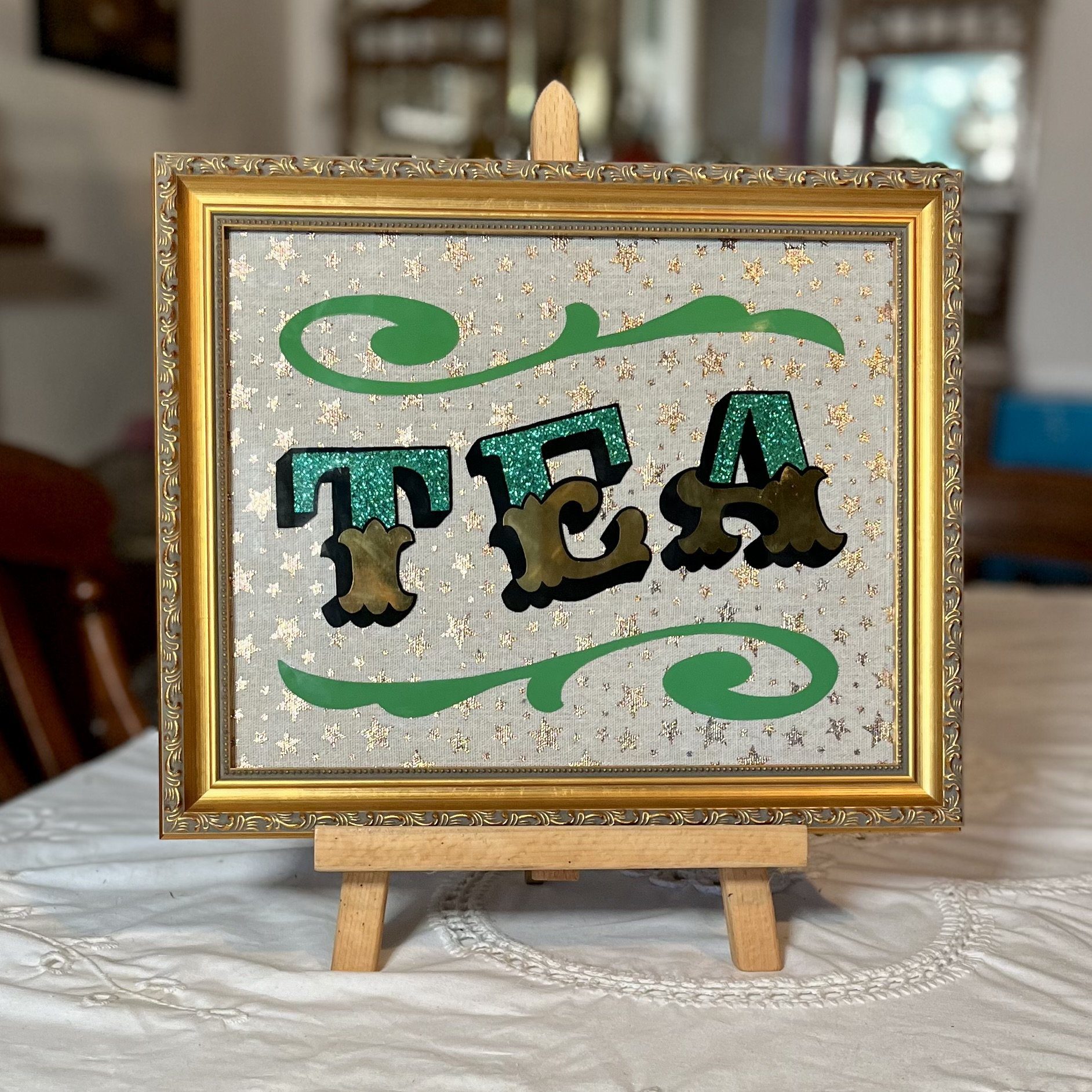 ‘TEA’ Glass Gold leaf Circus Style Lettering Artwork with Glitter and Decorative Scrolls