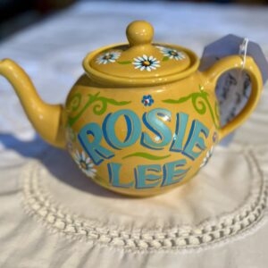 Yellow ceramic teapot featuring the words Rosie Lee handpainted in light blue signwriting enamels and also featuring daisies and canal roses