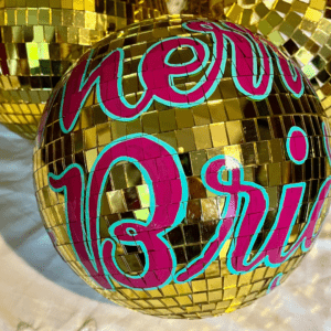 'Merry & Bright' DISCO mirror ball. Hand-painted script lettering in magenta and teal enamel paints onto gold mirror ball measuring approx 30cm diameter