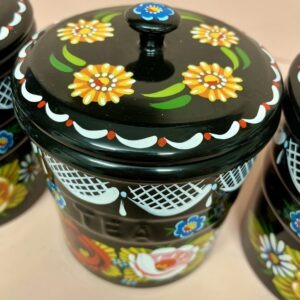 Close up detail of handpainted daisies on tea coffee sugar pots