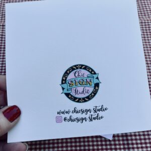 Back of ornamental hand-lettered greetings card showing Chic Sign Studio logo, website & Instagram handle